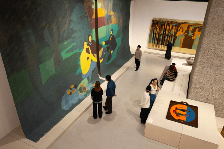 Museum visitors viewing large contemporary paintings